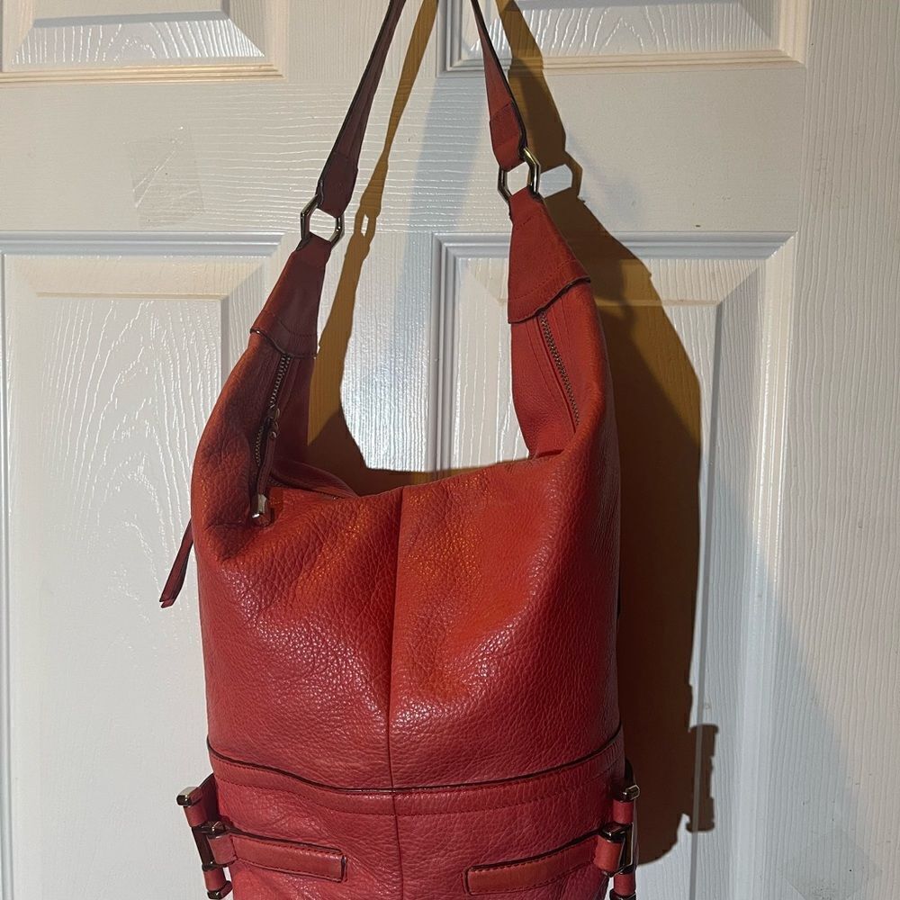 B Makowsky leather orange Hobo bucket style shoulder bag  silver tone hardwares